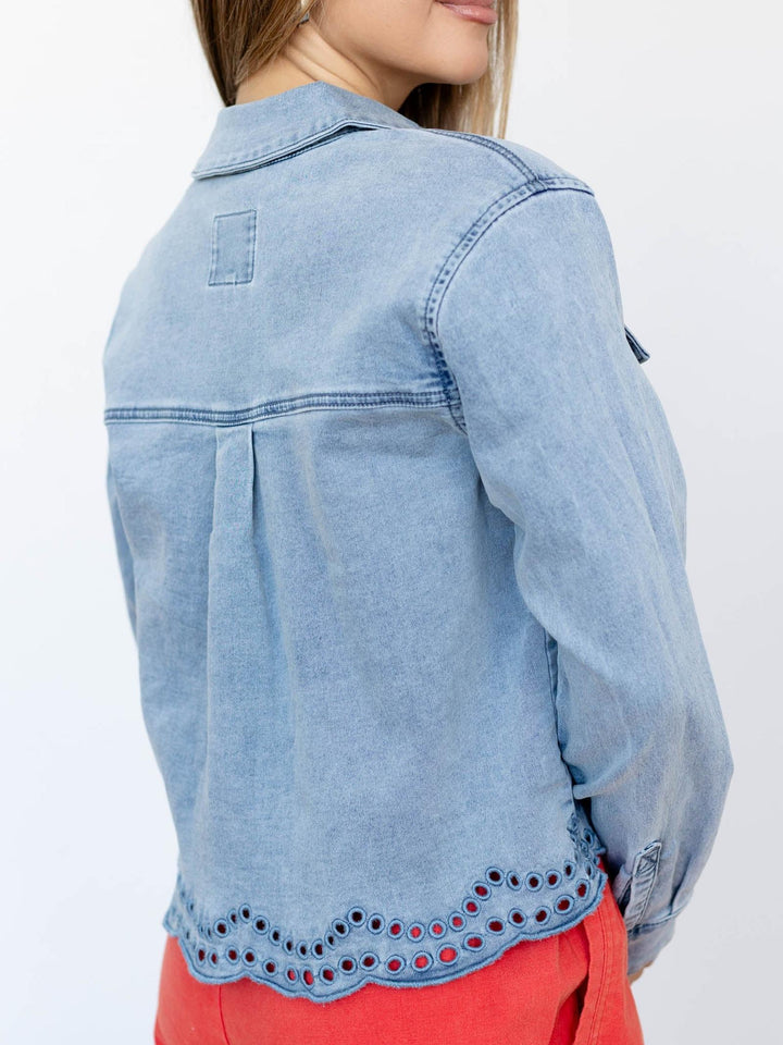 Light blue denim jacket with decorative hem on a white background