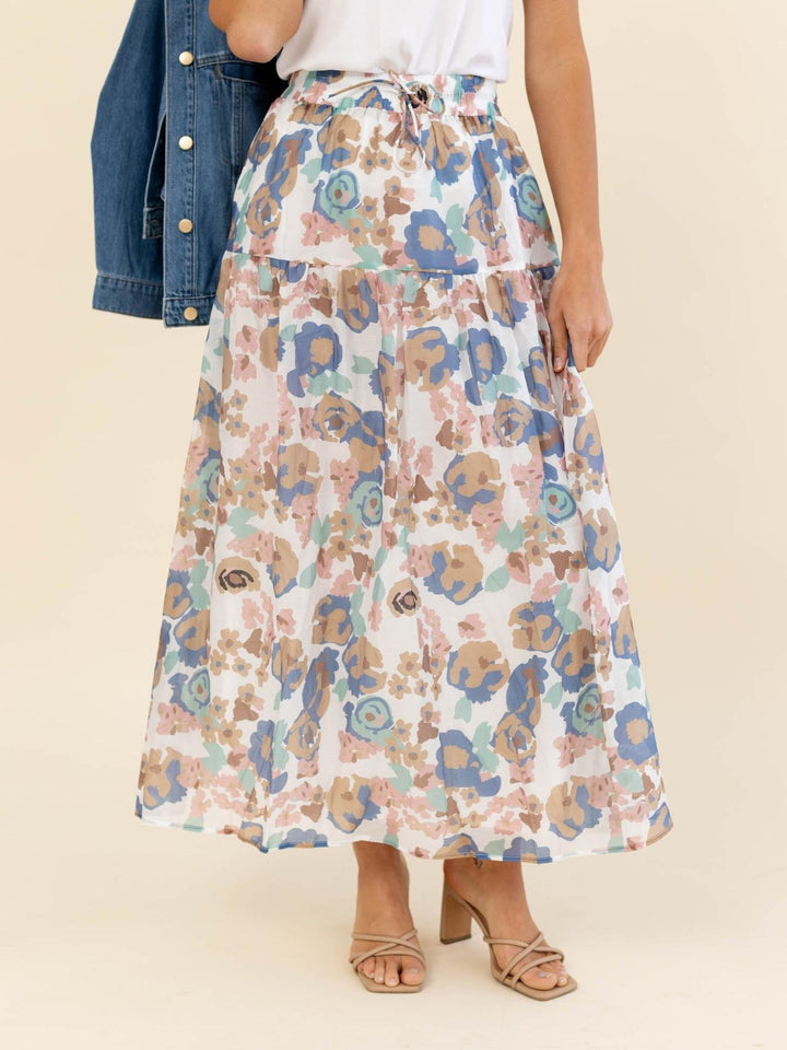 Woman wearing a floral skirt with a plain background