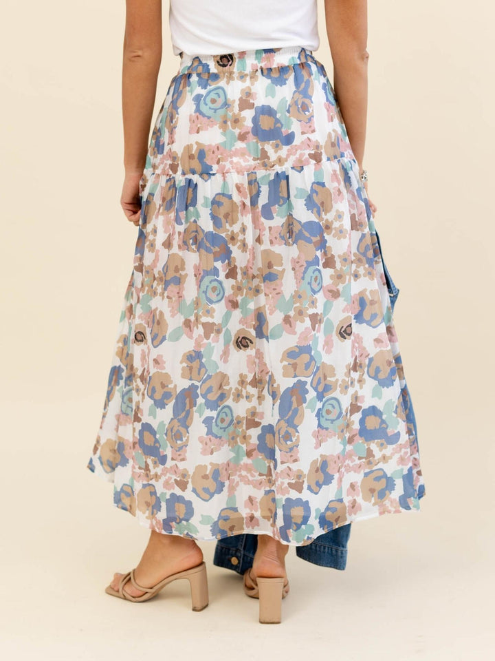 Floral patterned skirt worn by a person on a beige background