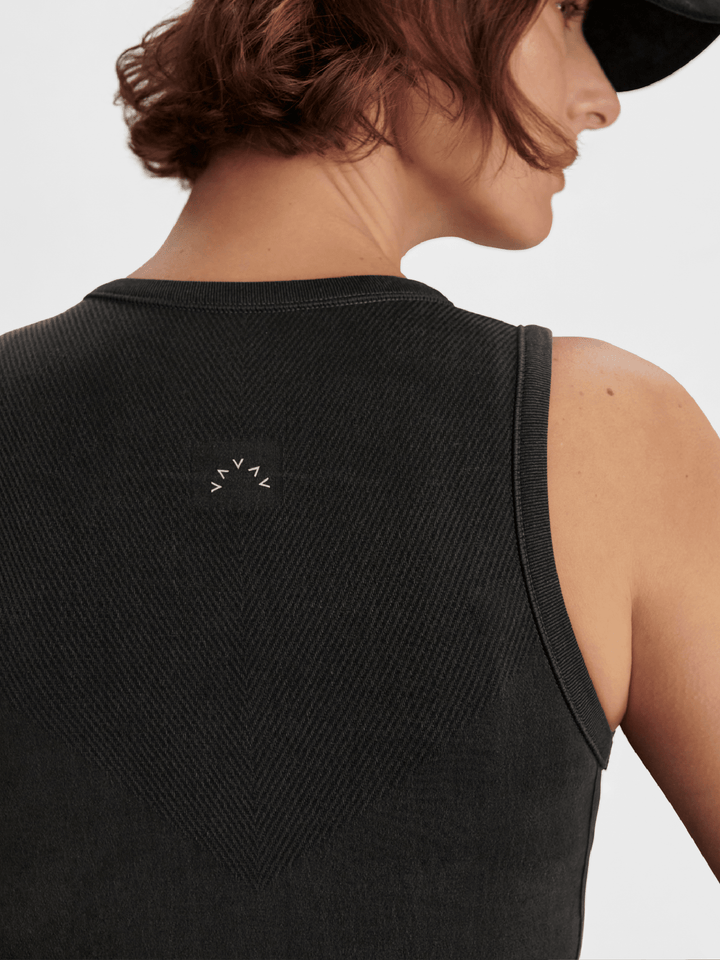 Black sleeveless top with a small logo on the back, worn by a person.