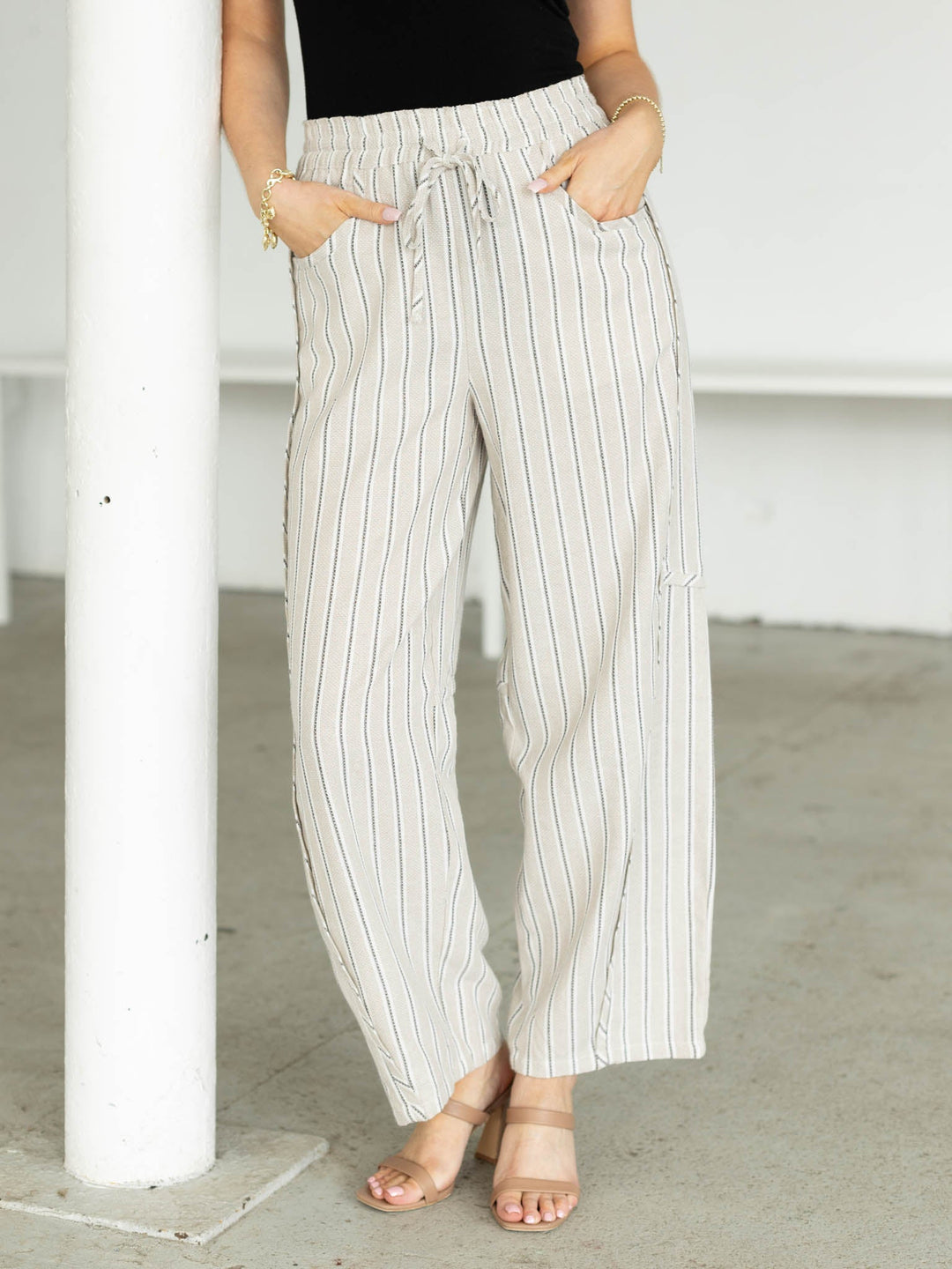 Person wearing white and gray striped pants in an indoor setting