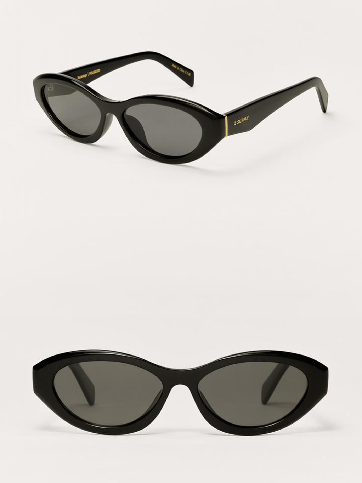 Black cat-eye sunglasses with gold accents on a white background