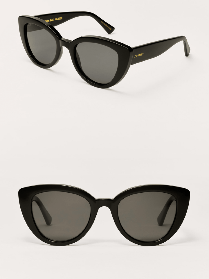 Black cat-eye sunglasses with dark lenses on a white background