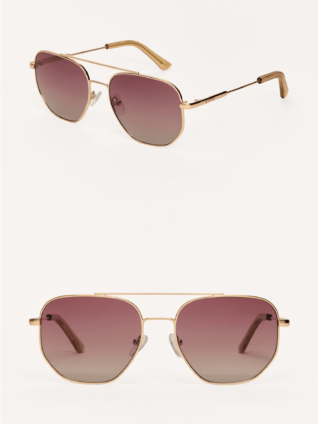 Gold-framed sunglasses with pink gradient lenses on a white background