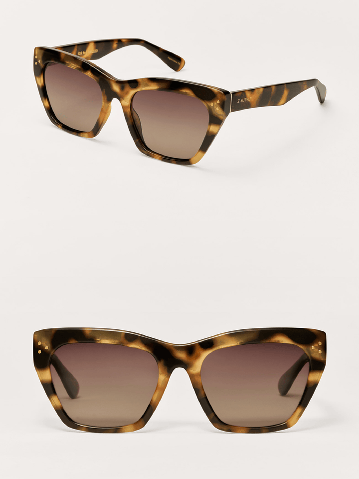 Tortoiseshell sunglasses with brown gradient lenses on a white background
