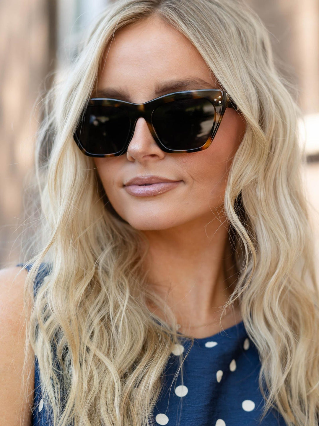 Woman wearing Z Supply Park Ave sunglasses with brown tortoise-grey frames and dark lenses.