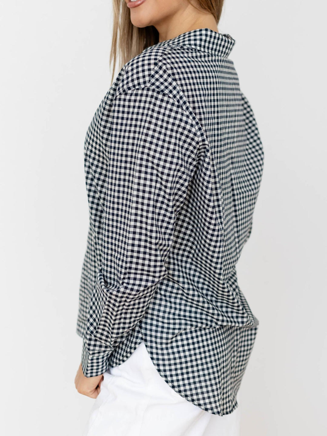Black and white checkered shirt worn by a person on a white background