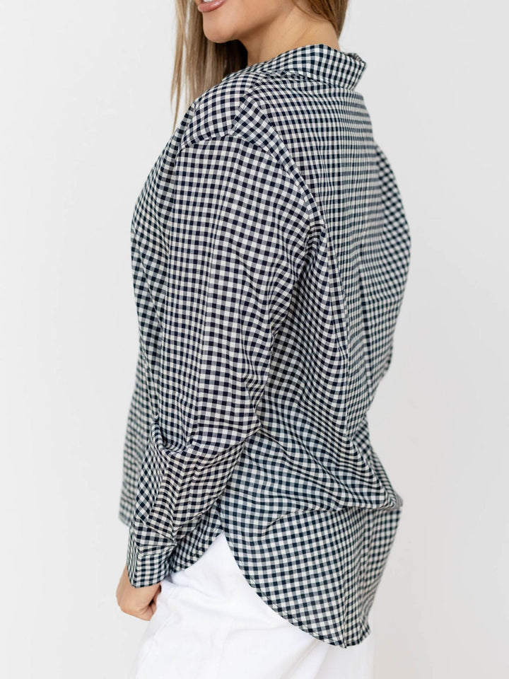 Black and white checkered shirt worn by a person on a white background
